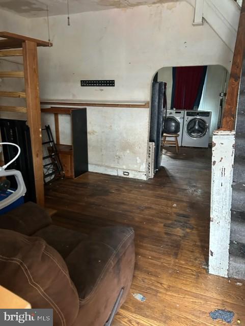 living room with separate washer and dryer and hardwood / wood-style floors