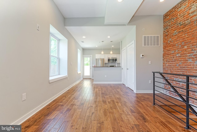 unfurnished living room featuring hardwood / wood-style floors