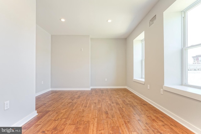 unfurnished room with light hardwood / wood-style floors