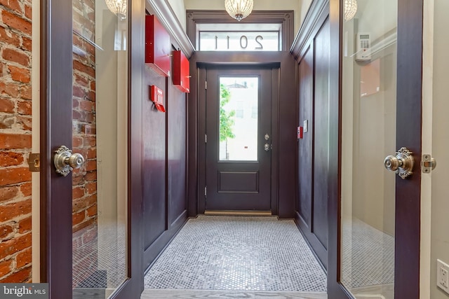 doorway featuring brick wall