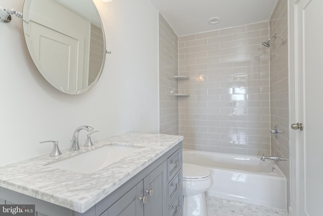 full bathroom with tiled shower / bath combo, vanity, and toilet