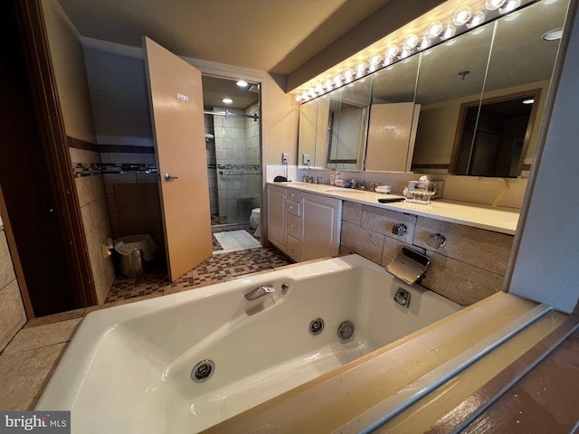 full bathroom featuring shower with separate bathtub, vanity, and toilet