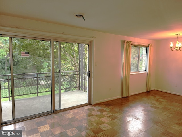 unfurnished room featuring a notable chandelier