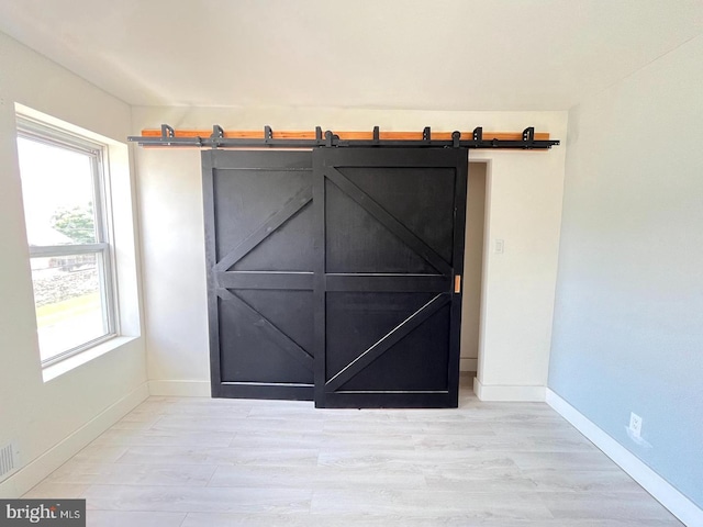 details with wood-type flooring and a barn door