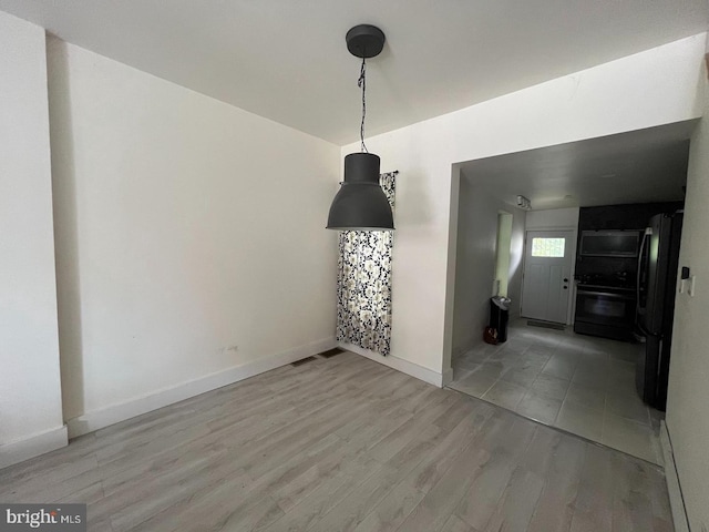 unfurnished dining area with hardwood / wood-style floors