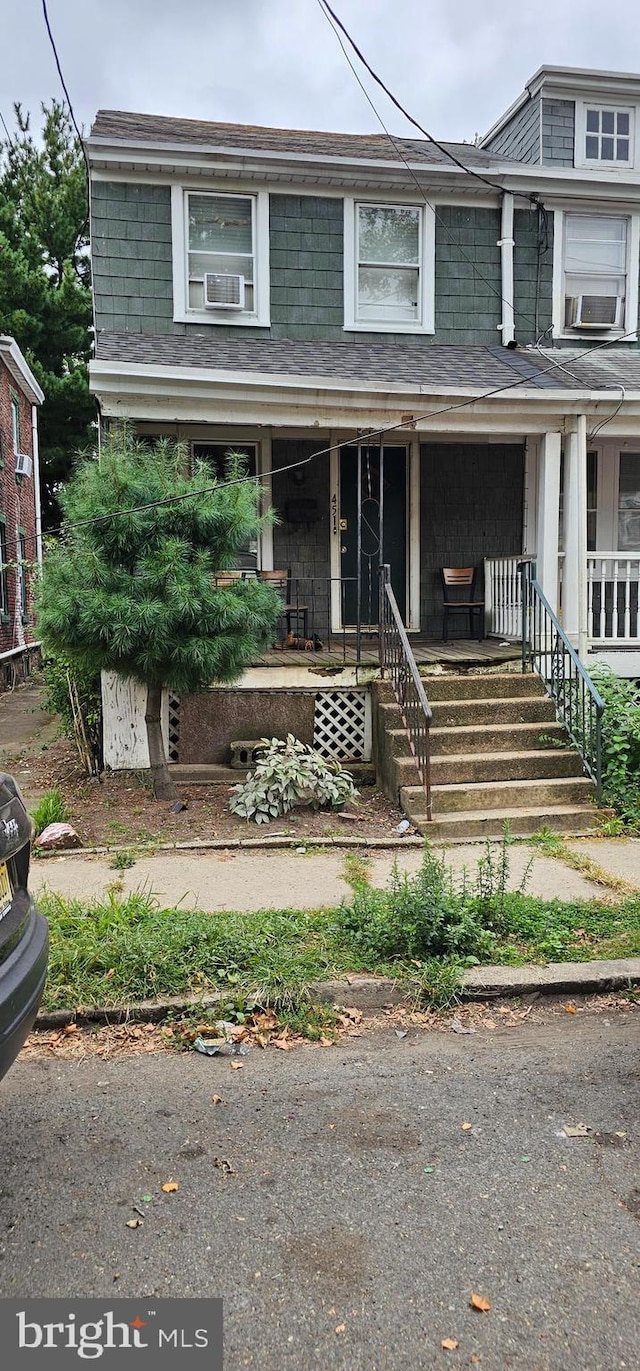 view of front of property featuring cooling unit and covered porch