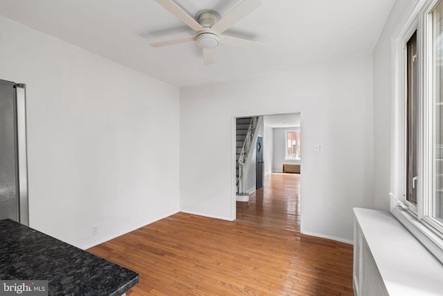 empty room featuring wood-type flooring and ceiling fan