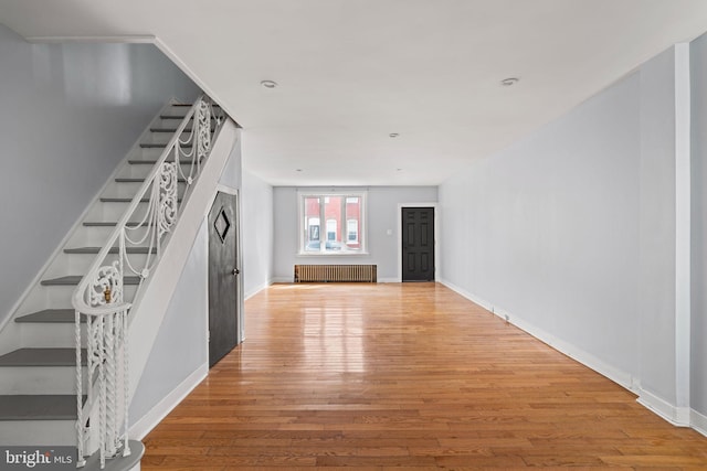 entrance foyer featuring radiator and light hardwood / wood-style floors