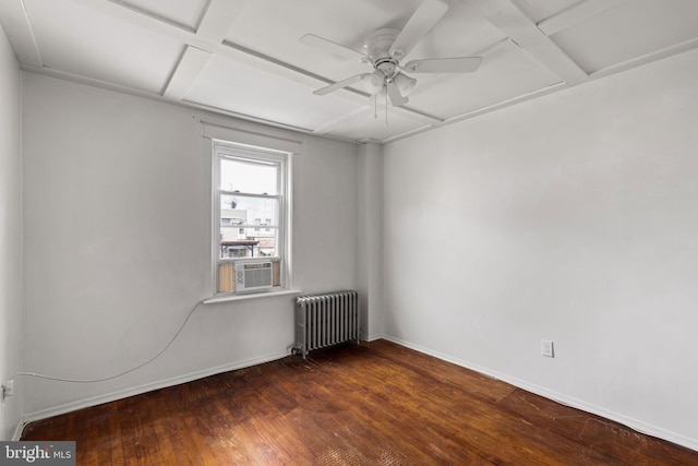 spare room with ceiling fan, coffered ceiling, dark hardwood / wood-style floors, and radiator heating unit