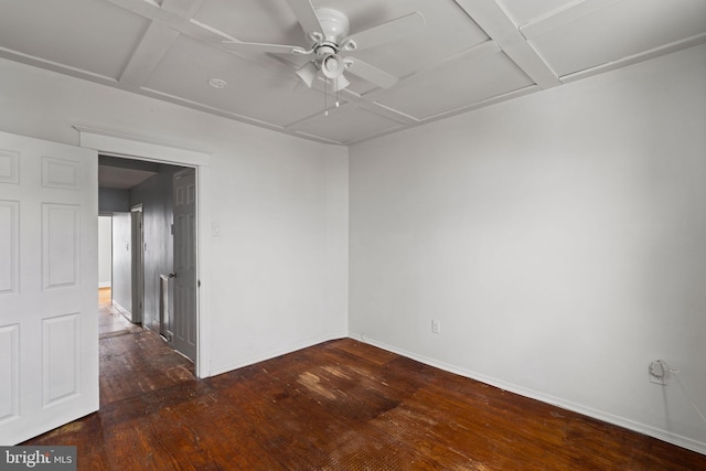 spare room featuring ceiling fan, dark hardwood / wood-style floors, and coffered ceiling