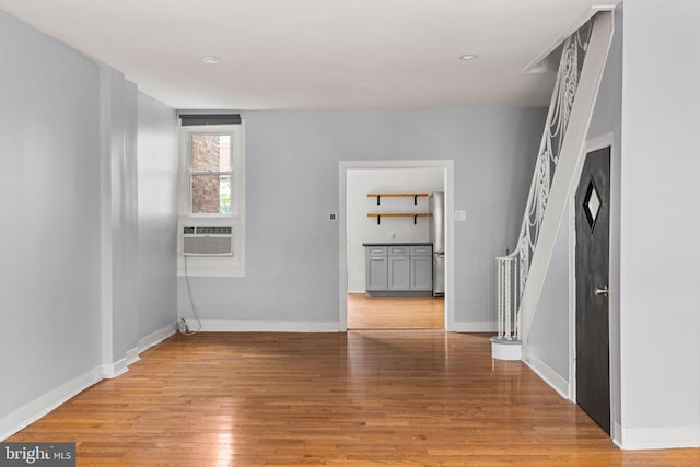 interior space with cooling unit and light hardwood / wood-style flooring