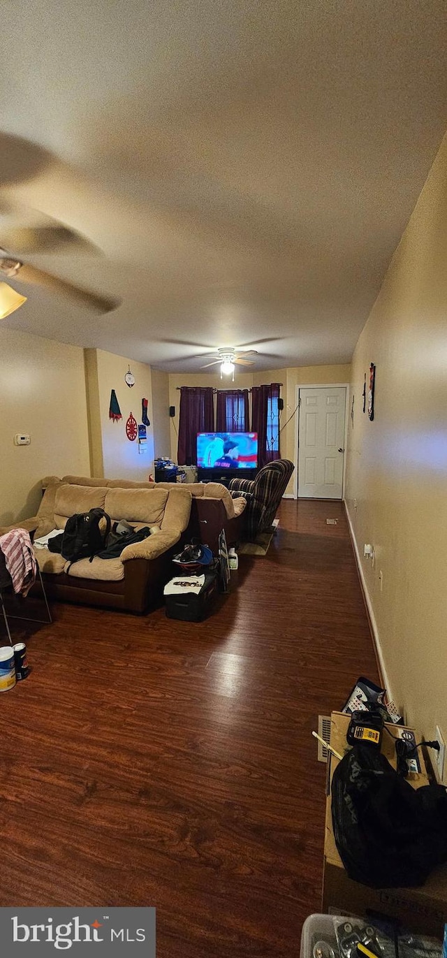 living room featuring a textured ceiling, dark hardwood / wood-style floors, and ceiling fan