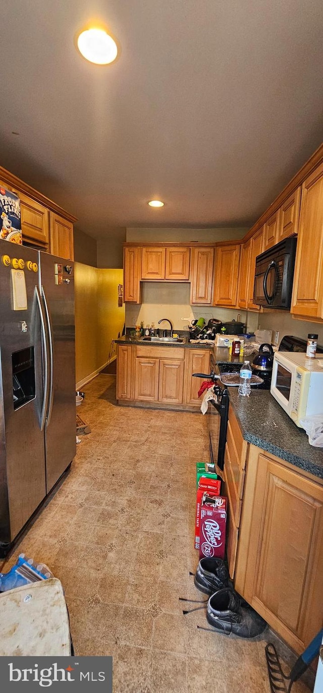 kitchen featuring sink and stainless steel fridge with ice dispenser