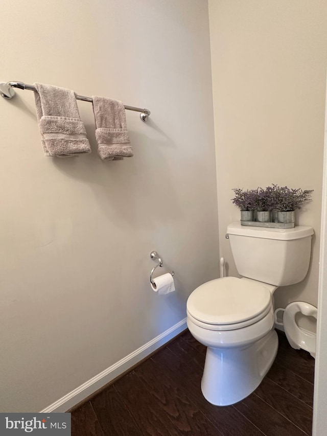 bathroom featuring hardwood / wood-style flooring and toilet