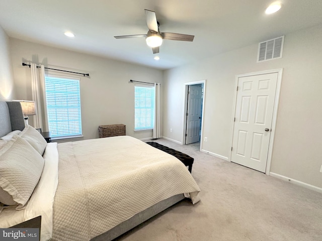 carpeted bedroom featuring ceiling fan and multiple windows