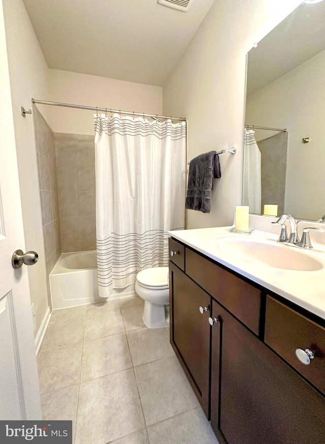 full bathroom with tile patterned flooring, vanity, shower / tub combo, and toilet