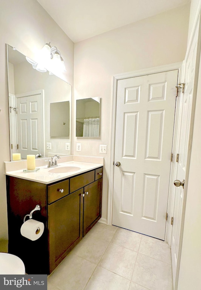 bathroom with tile patterned flooring and vanity