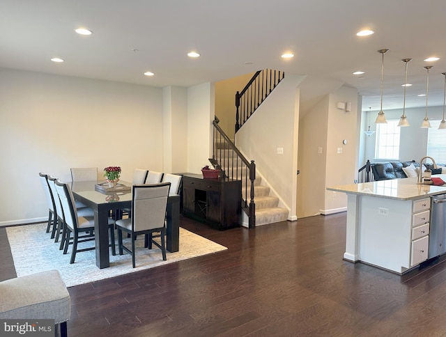 dining room with sink and dark wood-type flooring