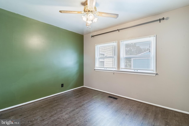 unfurnished room featuring ceiling fan and dark hardwood / wood-style floors