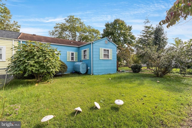 rear view of house with a yard