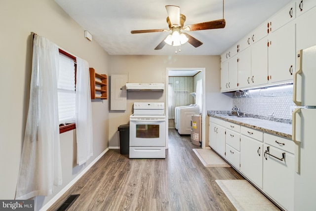 kitchen with washer / clothes dryer, tasteful backsplash, white cabinets, white appliances, and dark hardwood / wood-style floors