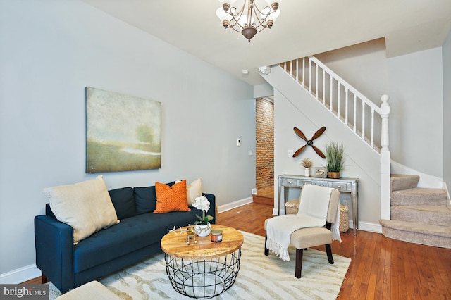 living room with wood-type flooring and a notable chandelier