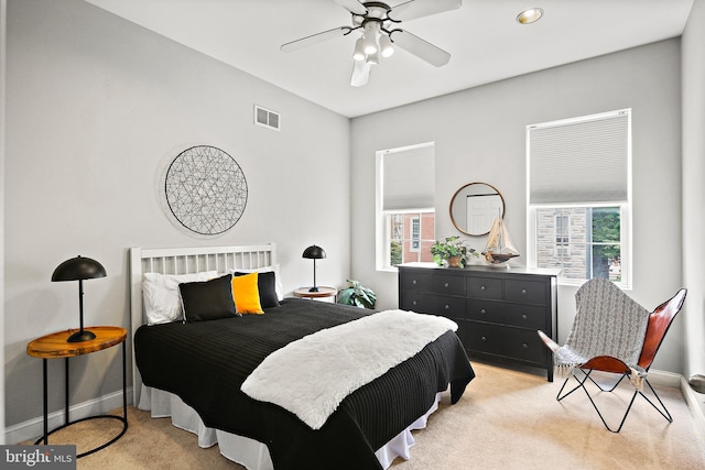 bedroom with light carpet and ceiling fan