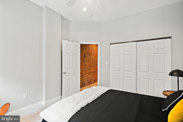 bedroom with a closet, ceiling fan, and light carpet