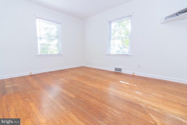 unfurnished living room with a fireplace and hardwood / wood-style floors