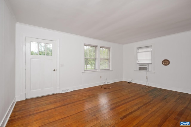 entryway with crown molding, dark wood-type flooring, and a wealth of natural light