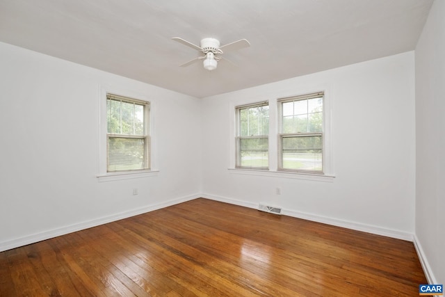 spare room with ceiling fan and hardwood / wood-style flooring