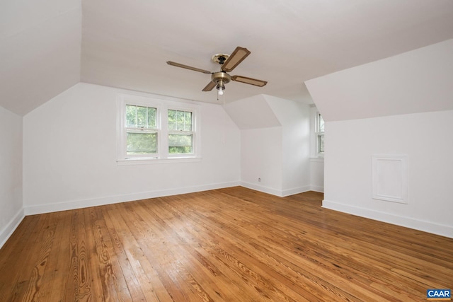 additional living space with wood-type flooring, lofted ceiling, and ceiling fan