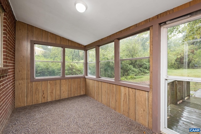 unfurnished sunroom with lofted ceiling and a wealth of natural light