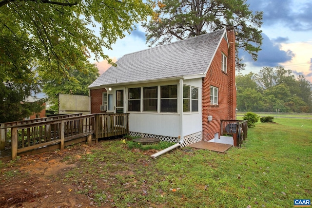 view of front of house with cooling unit, a yard, and a wooden deck