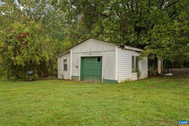 view of outdoor structure featuring a lawn