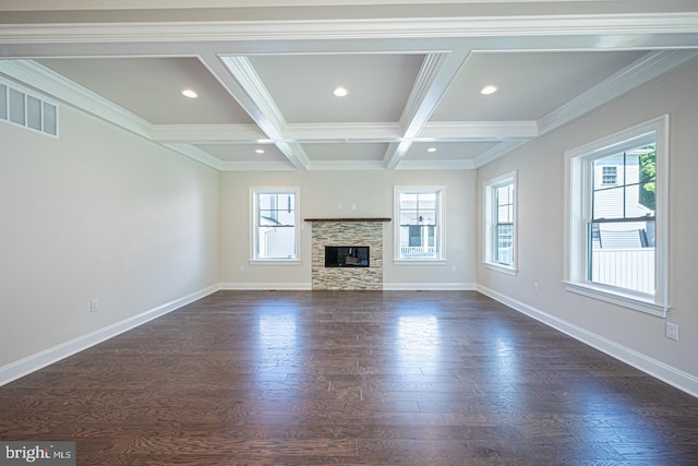 unfurnished living room with coffered ceiling, dark hardwood / wood-style flooring, a stone fireplace, and beam ceiling