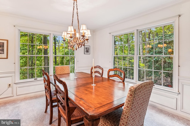 dining room featuring light colored carpet, an inviting chandelier, and a wealth of natural light