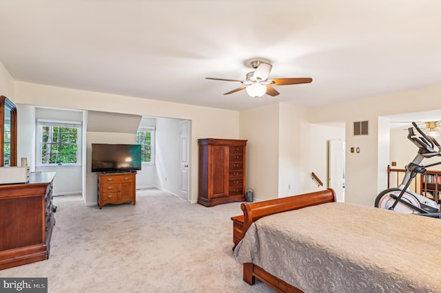 bedroom with ceiling fan and light carpet