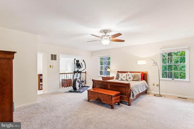 bedroom with ceiling fan and light colored carpet