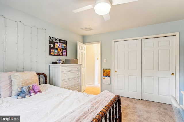 bedroom with light carpet, ceiling fan, and a closet