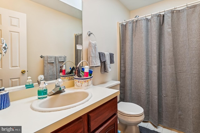 bathroom with vanity, toilet, and tile patterned floors