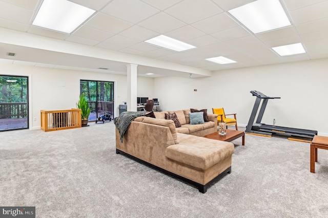 carpeted living room featuring a paneled ceiling