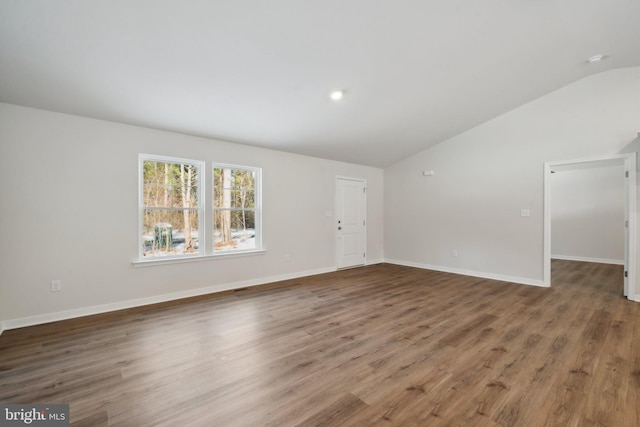 unfurnished living room with dark hardwood / wood-style flooring and vaulted ceiling