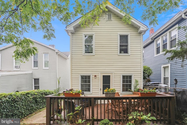 rear view of house featuring a deck