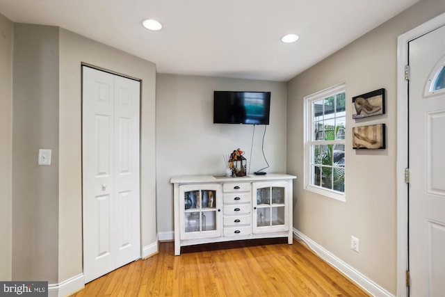 corridor with light hardwood / wood-style floors