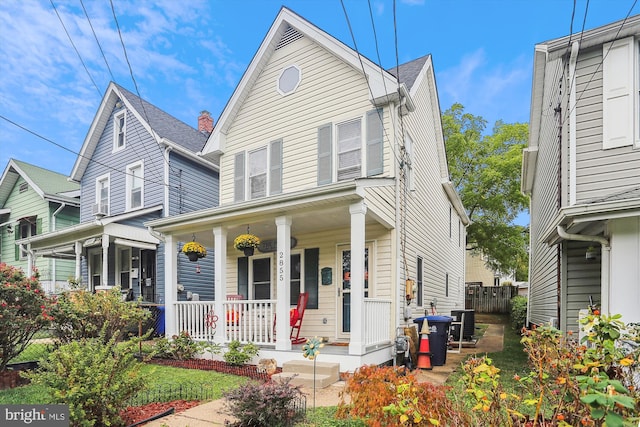 front facade featuring central AC unit and a porch