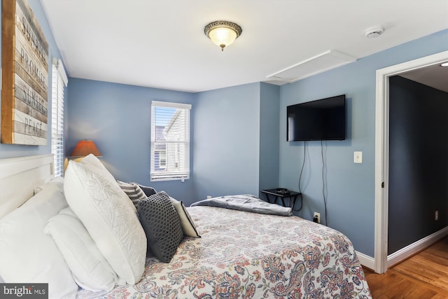 bedroom with hardwood / wood-style floors