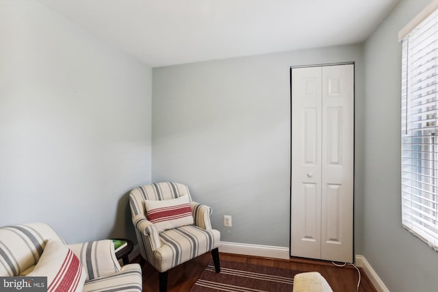 sitting room with dark wood-type flooring