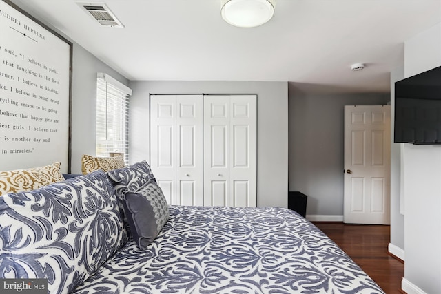 bedroom featuring a closet and dark wood-type flooring