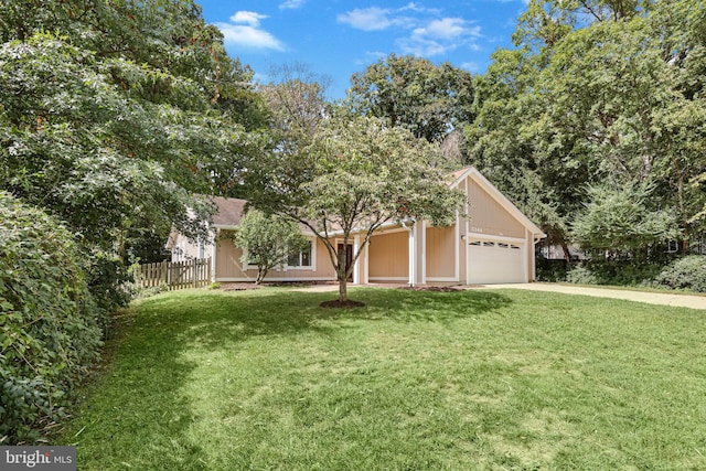 view of front of property featuring a garage and a front yard